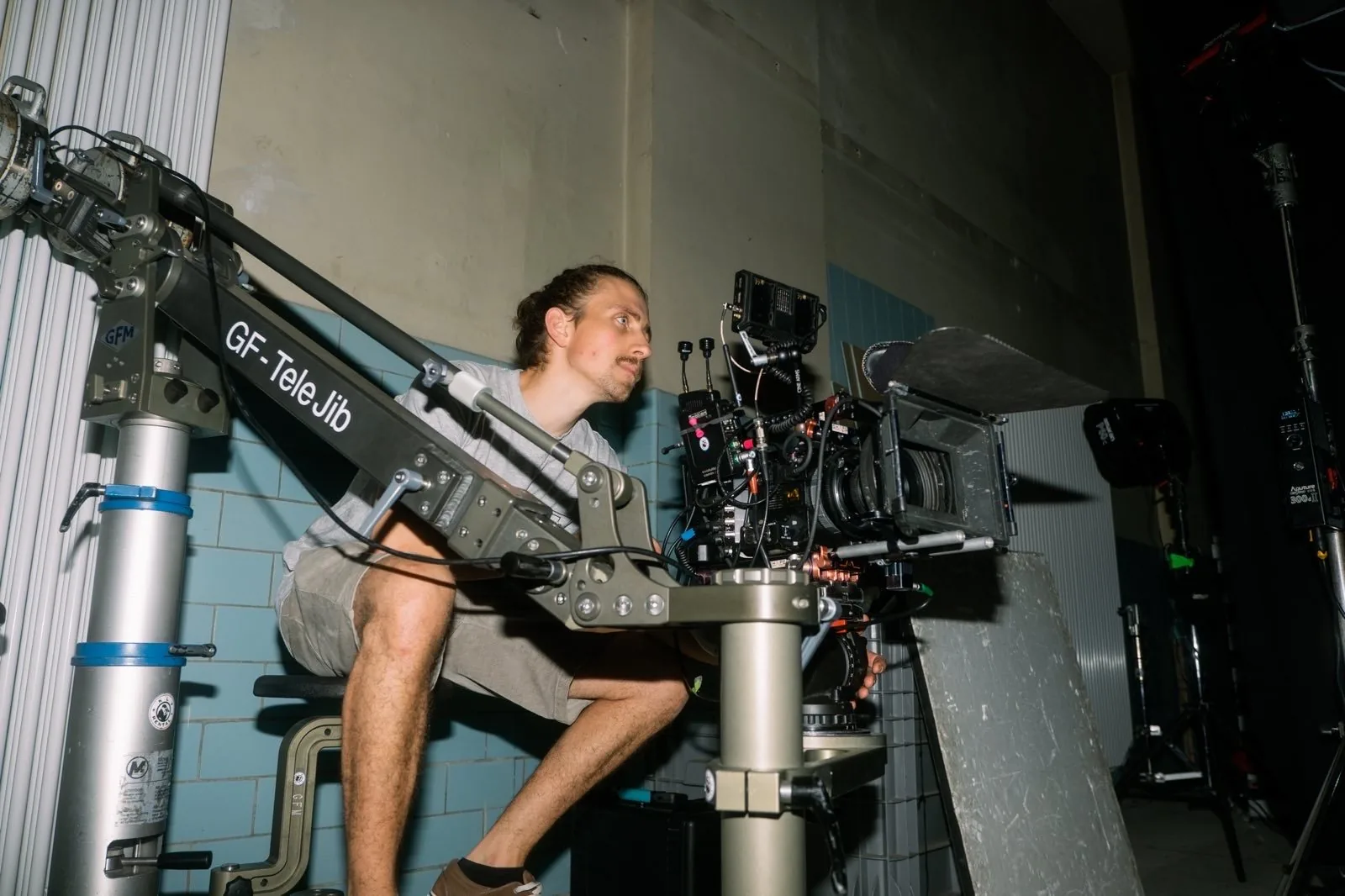 Frederic T. Kuntz crouched beside a camera mounted on a telescopic jib